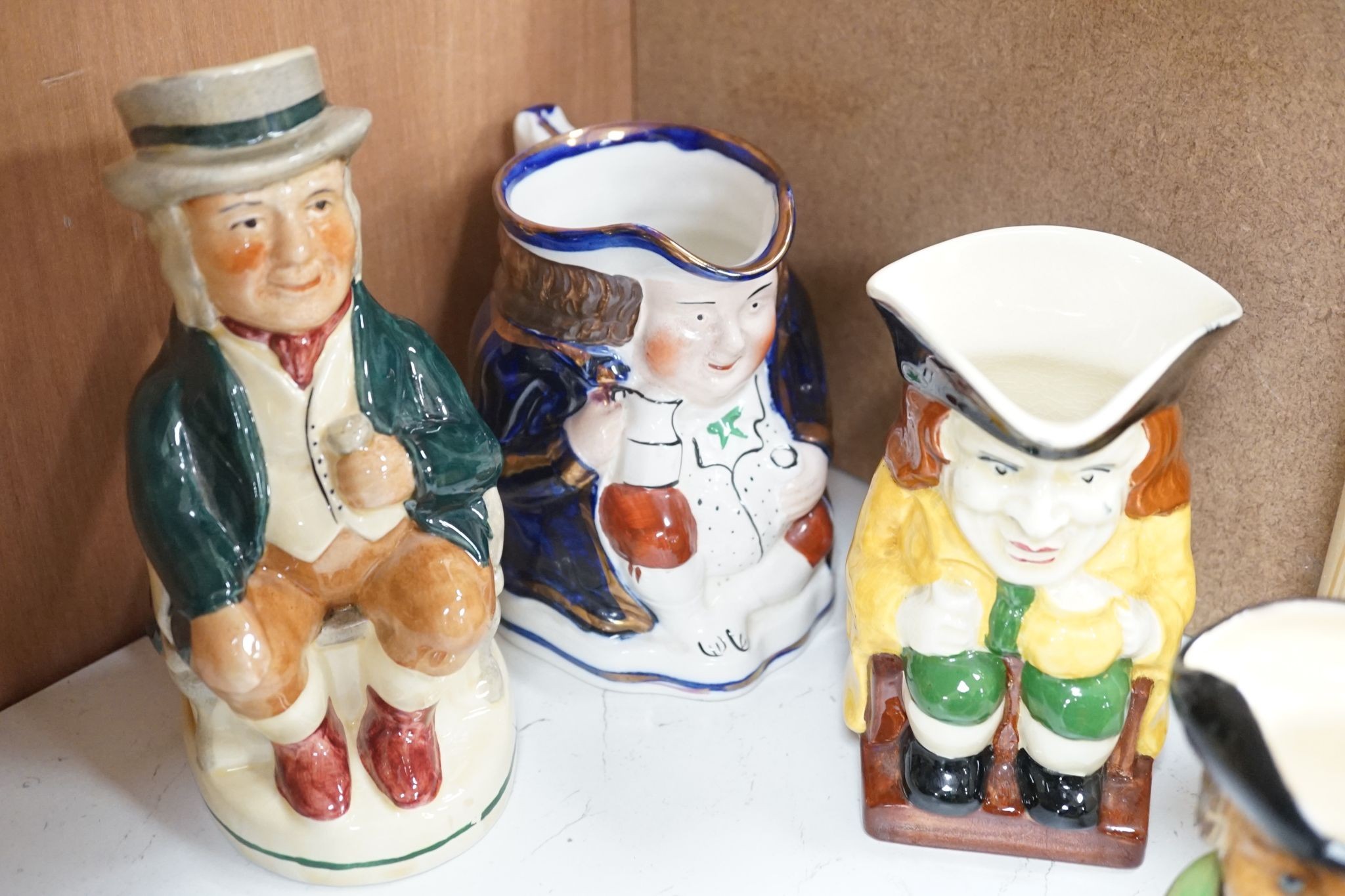 A Sylvac Coachman Toby jug, and eleven others, tallest 17cm